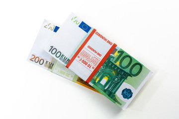 Euro cash in bundles of one hundred and two hundred banknotes, Euro money Euro on a white background, isolated on a white background