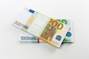 Euro cash in bundles of one hundred and two hundred banknotes, Euro money Euro on a white background, isolated on a white background