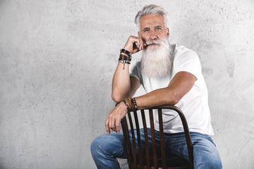 Handsome bearded senior man posing in studio