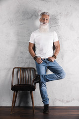 Handsome bearded senior man posing in studio