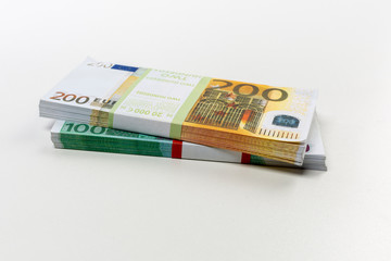 Euro cash in bundles of one hundred and two hundred banknotes, Euro money Euro on a white background, isolated on a white background