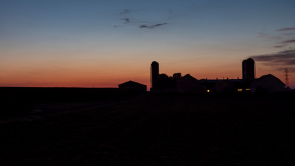 Sunrise Over an Amish Farm with Blues and Reds