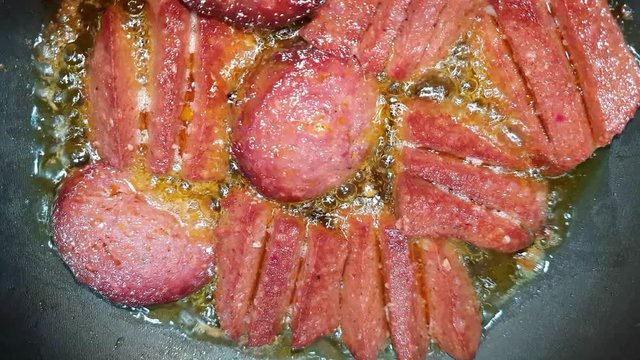 Turkish sausage - sucuk - cooking with butter on a pan