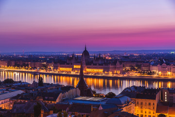 Naklejka premium Panoramic cityscape of Hungarian parliament building on the Danube river. Colorful sunrise in Budapest, Hungary