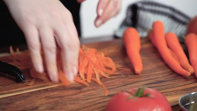 Step by step. Slicing orange carrots into the small cubes for beet soup, borscht.