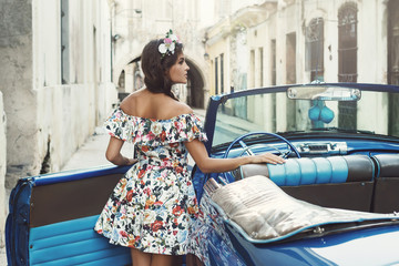 Woman wearing beautiful dress and retro convertible car