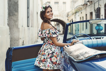 Woman wearing beautiful dress and retro convertible car