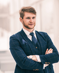 newcomer businessman in a business suit stands near the window,