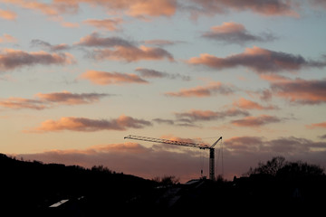 Crane at a construction site at sunset