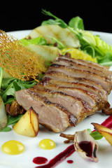 grilled duck fillet with sauce, vegetables and mushrooms