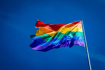 Enormous 20x30 foot rainbow flag flying proud over Harvey Milk Plaza in the Castro district of San Francisco California