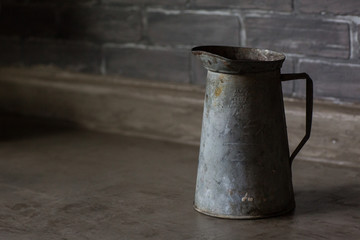 rustic metal pitcher in dark gray kitchen