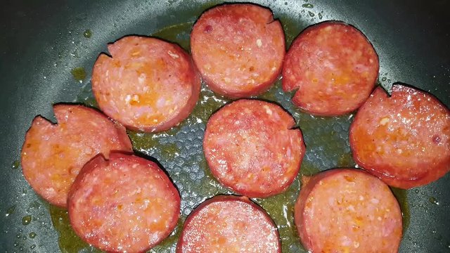 Turkish sausage - sucuk - cooking with butter on a pan