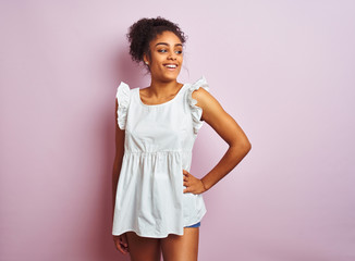 Young beautiful african american teenager girl standing wearing elegant white t-shirt