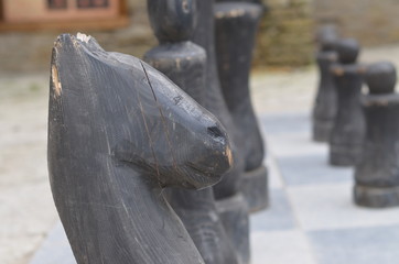  Huge wooden chess on a stone chessboard