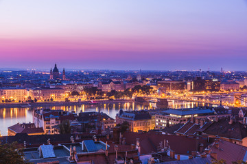 Fototapeta na wymiar Panoramic cityscape of Saint Stephen basilica with famous Chain Bridge on the Danube river. Colorful sunrise in Budapest, Hungary