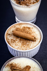 jars of rice pudding with cinnamon. Typical porridge from Brazil made with rice, condensed milk and coconut. Brazilian food typical of rural parties of June and July. Gastronomic tourism concept.
