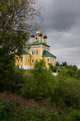 Fototapeta na wymiar yellow Nikolo-embankment temple on a cloudy summer day in Murom Russia