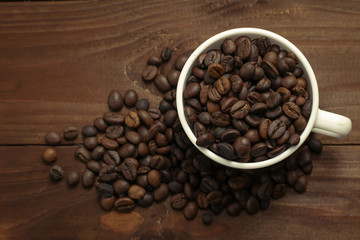 Cup with coffee grains on wooden table