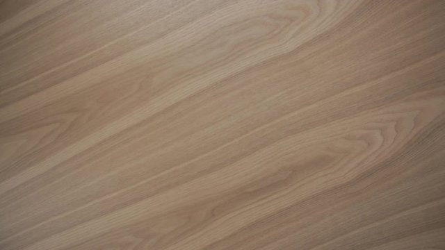 Woman's right hand take off plain empty white plate from wooden table TOP VIEW