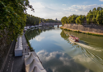 Naklejka premium Rome, Italy - Beautiful summer view of the river Tiber with the dome of St. Peter's Basilica in the background