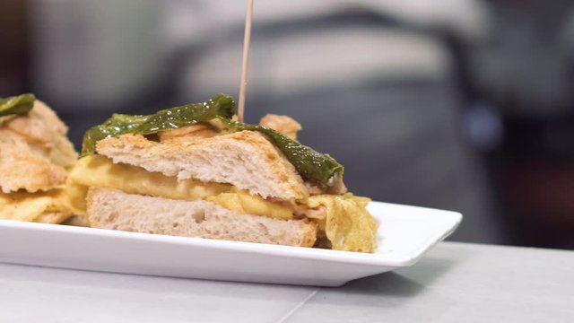 Chef preparing delicious typical Spanish food, Omelette tapa or Pintxo of omelette .