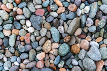 Close up of rounded and polished beach rocks.