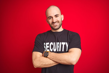 Young safeguard man wearing security uniform over red isolated background happy face smiling with...