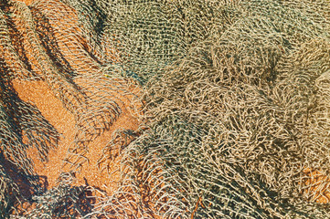 Fishing net is drying on the sand, selective focus.