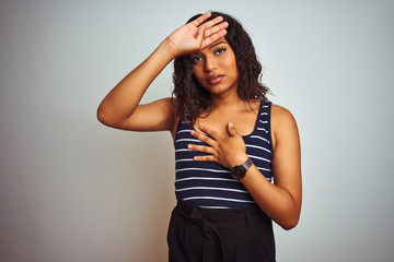 Transsexual transgender woman wearing striped t-shirt over isolated white background Touching forehead for illness and fever, flu and cold, virus sick
