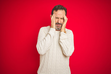 Handsome middle age senior man with grey hair over isolated red background with hand on headache because stress. Suffering migraine.