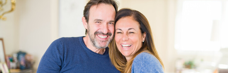 Romantic middle age couple sitting together at home