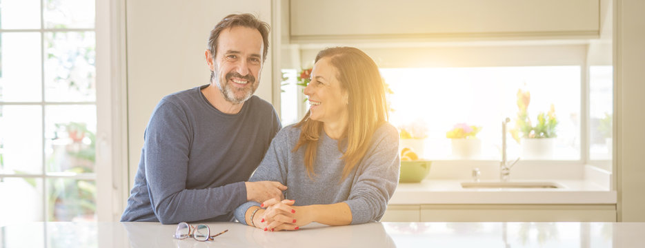 Romantic middle age couple sitting together at home