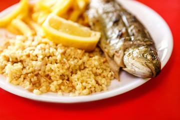 Fried fish with rice and lemon
