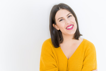 Beautiful brunette young woman smiling confident and cheerful over isolated white background wearing casual yellow sweater