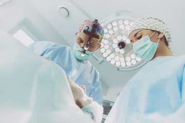 Man surgeon at work in operating room