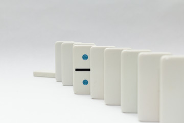 Line of dominos with one standing out from the line.