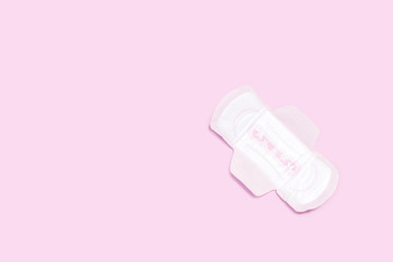 Female sanitary pad on pink pastel background.