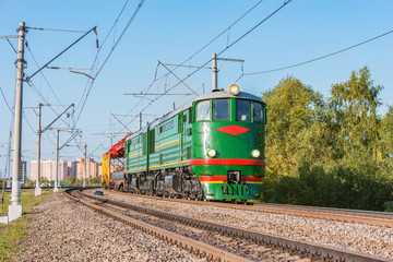 Fototapeta na wymiar Retro diesel locomotive with freight train at evening time. This type of locomotive was made since 1954.