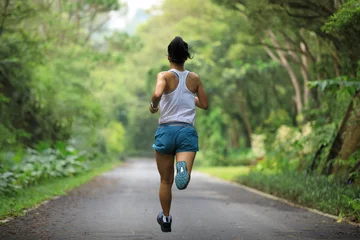 Keuken spatwand met foto Female runner running at summer park trail . Healthy fitness woman jogging outdoors. © lzf