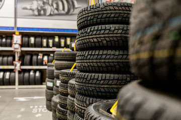 Car tires and wheels at warehouse in tire store. © volody10