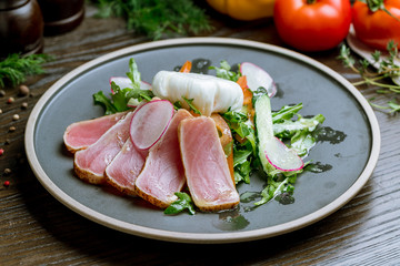 Nicoise with tuna on grey plate