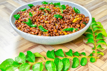 Close up of Red Cow Peas Curry and fresh surrounded curry leaves with water drops