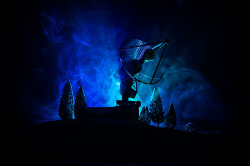 Fototapeta premium Silhouettes of satellite dishes or radio antennas against night sky. Space observatory.