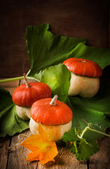 Decorative pumpkin, autumn still life, vintage wooden table, selective focus
