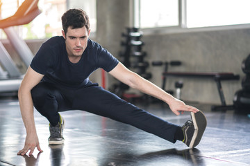 Fototapeta premium Handsome man exercise workout in gym fitness breaking relax and warm up with dumbbell for bodybuilding