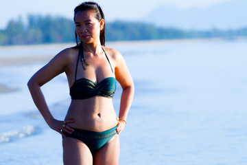 Woman shape large show bikini on beach