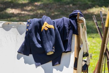 Union Army uniform laid over a white canvas tent during an American Civil War Re-enactment