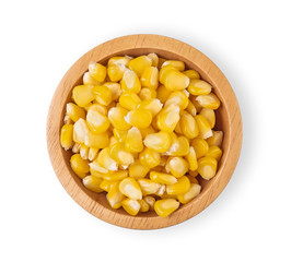 Sweet corn kernels in wooden bowl in white background. Top view