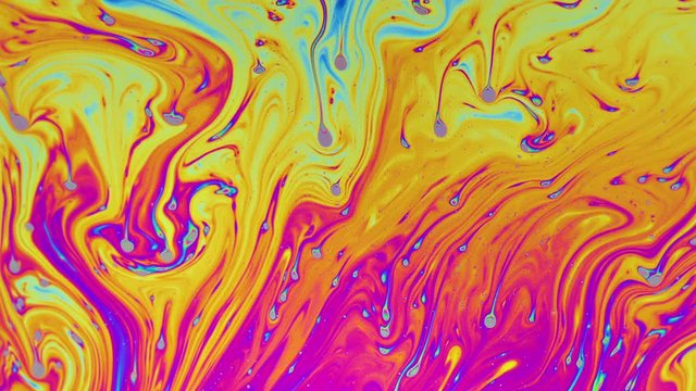 Macro shot of a soap bubble creates a colorful and psychedelic background
